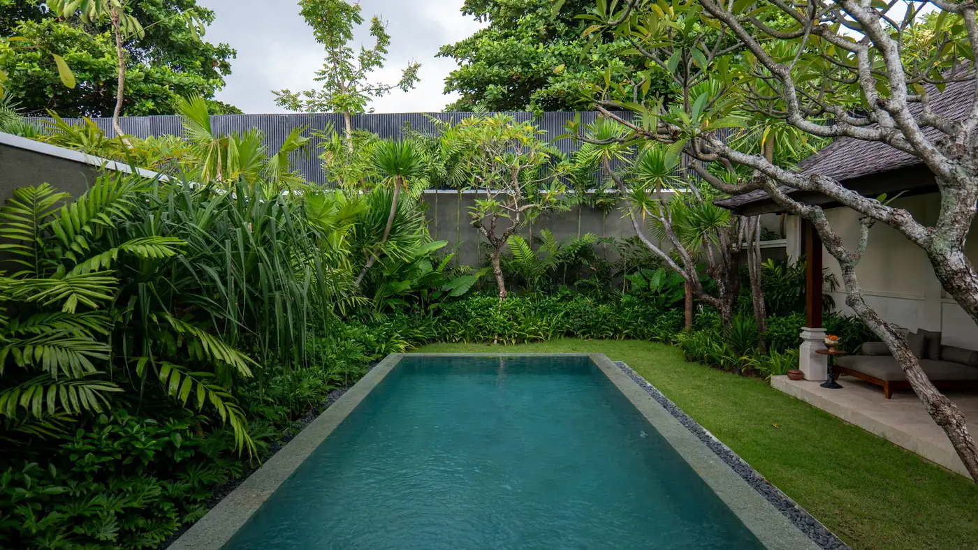 Illustrative photo: a villa pool in a tropical garden