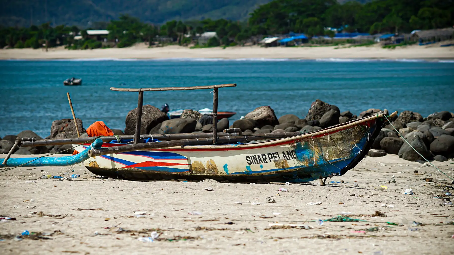 Illustrative photo of a traditional jukung boat on a sandy beach